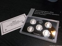 Front and back of 2012 US Mint America's Beautiful Quarters Silver Proof Set showing 5 silver proof quarters, displayed in original packaging with certificate of authenticity