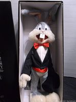 Bugs Bunny plush inside original box, dressed in tuxedo with red bow tie and cummerbund, holding black top hat
