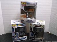 Three boxed Funko Pop figures including Overwatch Tracer, World of Warcraft Murghoul, and Deadpool Domino.