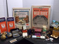 Photo showing an assortment of vintage collectibles including wearable accessories, paper ephemera, and small keepsakes.