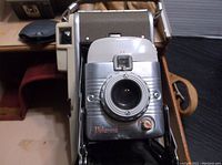 Front view of Polaroid Land Camera Model 80A showing lens and body