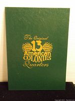 Green hardcover book with gold embossed title "The Original 13 American Colonies Quarters"
