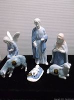 All six porcelain nativity figurines displayed on black background