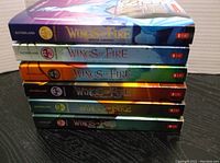 Six Wings of Fire books stacked, showing colorful spines and titles.