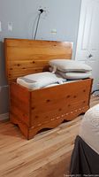 Blanket chest open showing interior lined with cedar. Chest filled with pillows for photo, pillows not included.