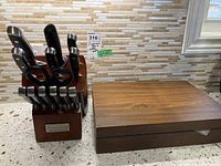 Full view of Cuisinart knife block holding kitchen knives, scissors and sharpener, next to flat wooden box for flatware set.