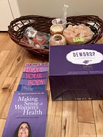 Overview of basket containing books, Himalayan salt stones, salt candle holder, small votive holder, and diffuser box