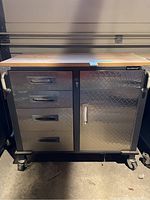 Front view of Mastercraft rolling tool cabinet showing four drawer fronts on left and single door on right on caster wheels