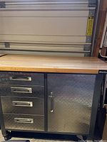 Full view of Mastercraft cabinet showing drawers, door, butcher block top, casters