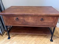 Full view of the wooden side table with metal legs, showing drawer and under shelf.
