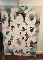 Full view of the abstract floral painting featuring white flowers with colored centers on a blue andbrown background.