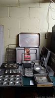 Overview of baking pans and sheets including muffin pans, round pans, loaf pans, and rectangular baking sheets.