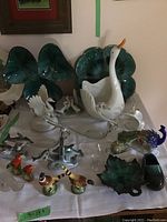 Overview of all ceramic and pottery figurines including swan shaped bowl, leaf-shaped dishes, and various birds