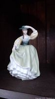 Front view of Royal Doulton Buttercup HN2309 porcelain figurine showing lady in pastel green dress and hat.