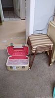 Toiletry case closed beside four stacked Metalmand stools.