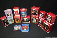 Photo showing the full lot of Christmas ornaments in original boxes arranged on black background.