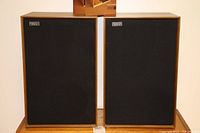 Front view of both speakers on stand with grille cloth in place