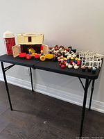 Overall view of barn, silo, tractor with wagons and collection of figures on folding table