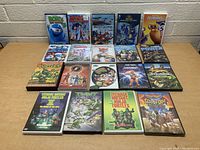 Front view of all 18 kids DVDs arranged in three rows against a brick wall.