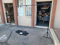 Photo showing the assembled photo backdrop stand with two adjustable tripod stands and horizontal crossbar.