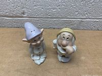 Front angle view of the Dopey and Sneezy figurine salt and pepper shakers showing detailed facial expressions and clothing