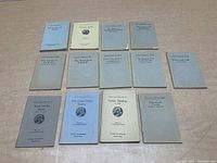 Twelve Little Blue Books laid out in two rows showing front covers, all vintage 1920s paperbacks in various shades of light blue and gray.