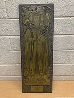 Full view of rectangular brass plaque on stone base featuring Sir Thomas Bullen with detailed engraving and decorative elements.