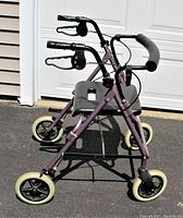 Front angled photo of the rose colored Deluxe Rolling Walker Guardian Envoy model 07887R showing four wheels, hand brakes, and padded seat.