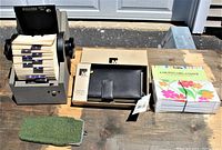 Overview of all four items on display, showing the Rolodex, leather clutch in box, coupon organizer in package, and green eyeglass case