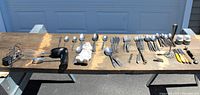 Wide view of all items including silverware, electric hand mixer, ceramic spoon rest shaped like Bugs Bunny, and other utensils.