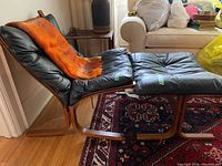 Side view of chair and ottoman with blanket draped