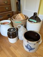 Front view of assorted crocks, jugs and baskets