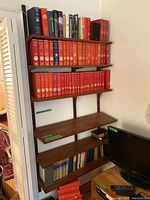Full view of assembled shelving with books across all six shelves.