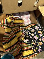 Box containing striped and floral patterned fabric pieces