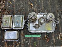 Full lot view from above showing all silver tray, tea and coffee pots, milk jug, sugar bowl, tongs, and three serving dishes.