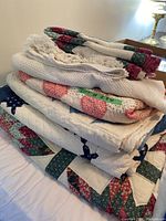 Side view of stacked quilts and blanket