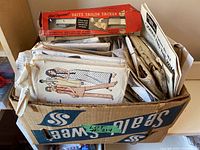 Box filled with a large number of vintage sewing patterns from brands including Vogue, Simplicity, and McCalls. Includes a Dritz Tailor Tacker tool box on top, but seller notes tool is not included in the lot.