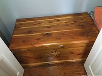 Top angle showing solid cedar wood with natural grain and knots, highlighting the surface and box edges.