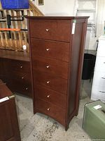 Front view of six-drawer dresser showing chrome knobs and overall condition