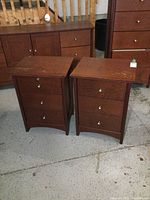 Pair of Norbec wooden night stands with visible surface wear, water marks on the tops shown side by side.