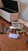 Overview photo showing all items in the lot including washboards, iron, laundry sign, and containers of buttons.