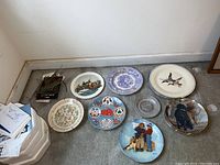 Overview of the 10 decorative plates arranged on the floor
