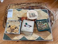 Seven placemats laid under multiple stacks of coasters showing vintage style botanical and fruit designs