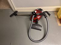 Full shot of Miele Compact C2 canister vacuum with hose, wand and two floor attachments