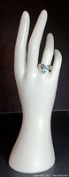 Ring displayed on a white mannequin hand showing overall look and size.