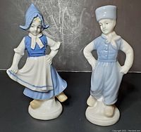 Front view of German Lippelsdorf Dutch boy and girl porcelain figurines from the 1960s, showing detailed traditional clothing and painted features.