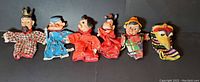 Full set of six vintage rubber face puppets in a row for identification and overview