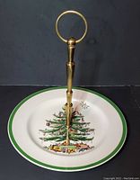 Full view of one tier serving plate with Christmas tree and brass handle.