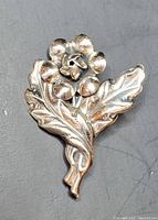 Front view of vintage Danecraft Felch & Co sterling silver rose pin showing the detailed flower and leaf design.