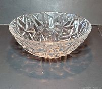 Front view showing intricate rock cut pattern on clear crystal bowl and its shallow depth.